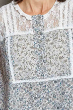 Pol printed woven sleeveless top with delicate white lace trim and soft blue green floral pattern with button closures