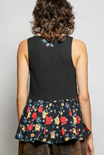 Black sleeveless peplum top with ribbed knit bodice and colorful floral woven patch skirt detail