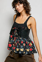 Black floral print peplum top with lace detailing and tied waistband featuring floral woven patch accents