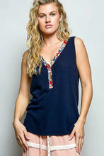 Navy blue ribbed knit sleeveless tank top with contrast floral neckband featuring colorful v neck trim