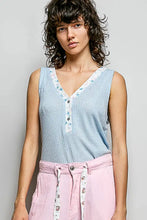 Light blue ribbed knit sleeveless top with v-neck and contrast floral neckband detail on the neckline