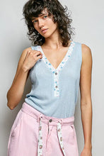 Light blue ribbed knit sleeveless top with contrast floral neckband and v-neck button closure for summer wear