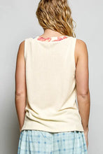 Cream-colored ribbed knit sleeveless top with contrast floral neckband and v-neck design from pol collection