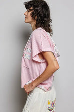 Soft pink pol short sleeve hooded top with patchwork floral details and back-open detail in textured fabric