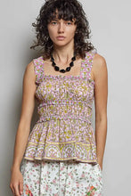 A pink pol smocked printed sleeveless top with ruffle trim and smocked printed square neckline waistband