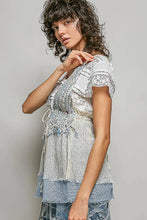 Layered distressed denim and lace top in light blue and white with subtle stripe pattern center tie detail