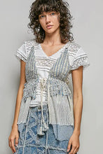 Light blue distressed denim skirt with layered ruffles and frayed edges paired with subtle stripe pattern cross-back string top with center tie detail