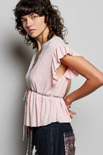 A soft pink cotton short sleeve blouse with ruffled sleeves cinched waistband and lace detail