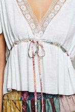 White lightweight short sleeve blouse with pleats lace-trimmed v-neck and floral tie belt for elegant wear