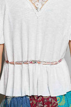 White textured short sleeve blouse with delicate lace trim neckline and colorful embroidered belt detail