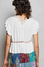 White short sleeve blouse with ruffled sleeves v-neckline embroidered lace trim and decorative waist belt band