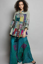 Pol tiered floral patchwork blouse with vibrant teal purple and yellow patterned fabrics and a tie neck detail