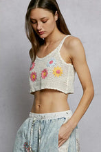 White crocheted crop top featuring colorful floral embroidery in pink yellow and blue with u-neck design crochet cami