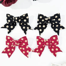 Polka dot bow hair clip set in black and red for stylish hair accessories