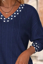 Navy blue ribbed knit long sleeve blouse with white polka dot bowknot detailing on v-neckline and sleeve cuffs