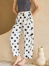 White cotton polka dot high waisted jeans with black dots and a tied waistband detail