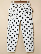 White denim polka dot high-waisted jeans with black dots and decorative bows at the waist