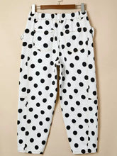 White denim high waisted jeans with black polka dots and visible stitching for stylish casual wear