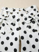 White denim polka dot high waisted jeans with black dots and large bow ties on front pockets