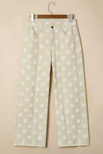 Cream-colored denim wide leg jeans with a white polka dot pattern and frayed hems high waisted design