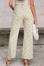 Polka dot high-waisted wide leg jeans in mint green with white polka dot pattern and frayed hem detail