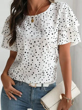 Polka dot layered ruffled short sleeve blouse on white background