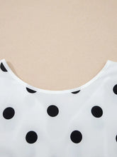 White blouse with black polka dots long sleeve featuring a rounded neckline in a polka dot long sleeve style