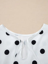 White polka dot long sleeve blouse with tie front neckline featuring classic black dots on lightweight fabric