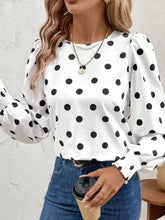 White blouse with black polka dots and puffed sleeves in a stylish polka dot long sleeve design