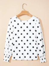 White long sleeve blouse with black polka dots and elastic cuffs in a polka dot long sleeve design