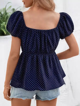 Navy blue polka dot peasant blouse with puffy short sleeves and peplum hem in lightweight fabric
