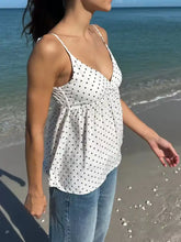 White polka dot v neck flowy cami with spaghetti straps and gathered waist in soft lightweight fabric