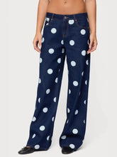 Dark blue denim polka dot wide leg jeans featuring bold white dots for a stylish casual look
