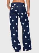 Dark blue denim polka dot wide leg jeans featuring a bold white dot wide leg pattern