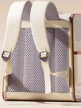 Cream-colored pet carrier backpack with mesh panels and brown trim