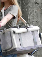 Gray mesh pet carrier bag with adjustable straps and rolled-up side panel
