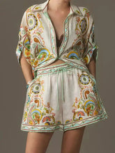 Printed button-up shirt and shorts set in vibrant off-white paisley print