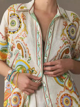 Vibrant off-white linen printed button up shirt with swirling paisley pattern