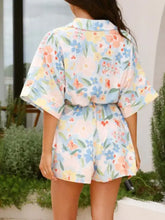 Printed half sleeve tie waist romper in light pink with pastel blooms
