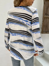 Printed half zip long sleeve top with abstract blue and black wavy stripes