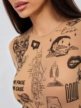 Sheer skin-toned mesh long sleeve bodysuit featuring intricate black ink tattoo print of symbols and phrases