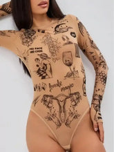 A sheer tan long sleeve bodysuit featuring intricate black ink-style tattoo-inspired graphics and text