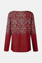 Red printed notched long sleeve T-shirt with ornate gold and silver pattern