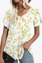 Woman in printed petal sleeve V-neck blouse with regular sleeve length