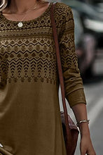 Woman in printed round neck long sleeve T-shirt with gold necklace