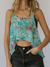 Printed scoop neck tank in turquoise with floral print lightweight fabric and asymmetrical hemline crop top