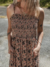 Printed smocked bodice maxi dress with red black leaf pattern