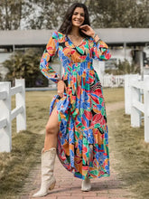 Woman in printed smocked tie balloon sleeve maxi dress with floral pattern