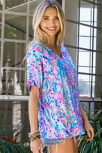 Woman in printed V-neck tee shirt with short sleeves and hem width