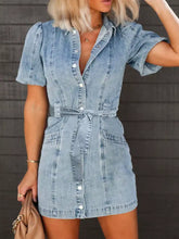 Light-wash mini denim dress with puff sleeves short sleeves button-front closure and tied waist belt